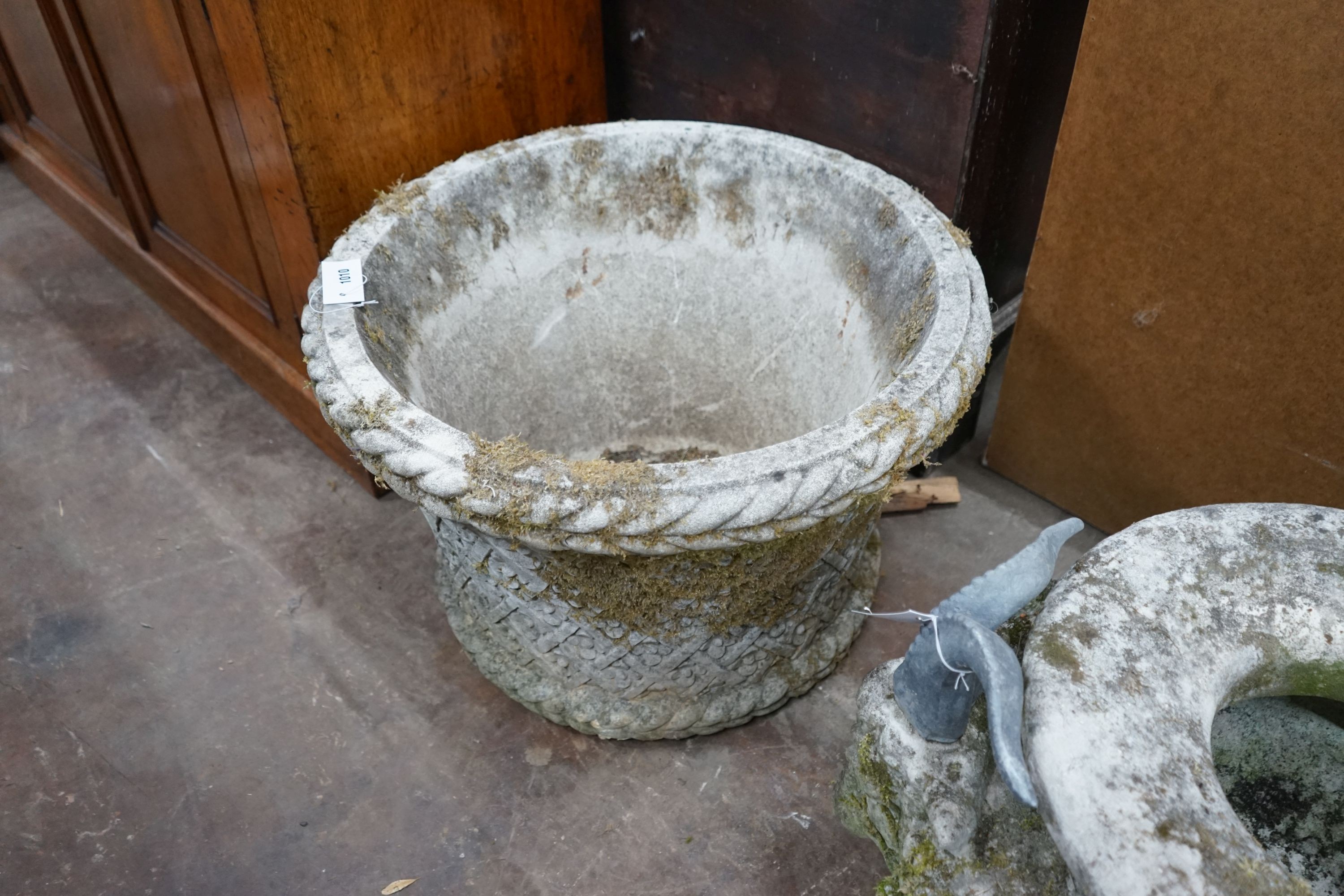 A large circular reconstituted stone garden planter, diameter 62cm, height 40cm